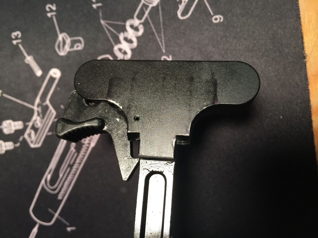 Underside of a Sig MPX charging handle, showing where it's impacting the upper.