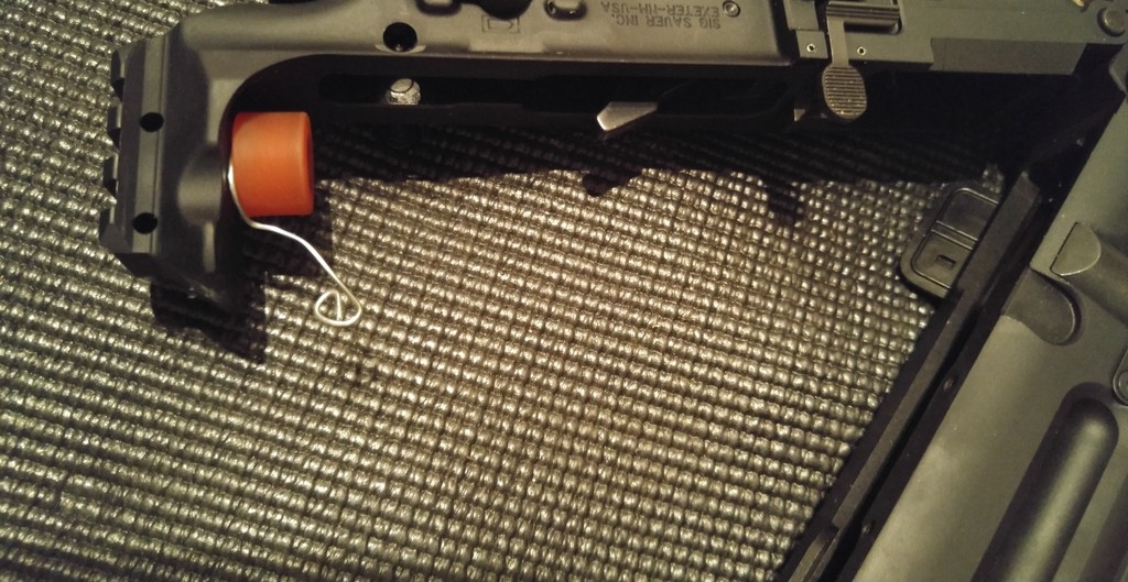 Bend the paperclip around the buffer screw and tighten it down (courtesy of Dieseljayy).