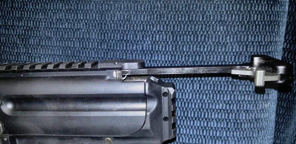The paperclip applies upward force to the charging handle, which prevents wear to the upper and lower (courtesy of Dieseljayy).