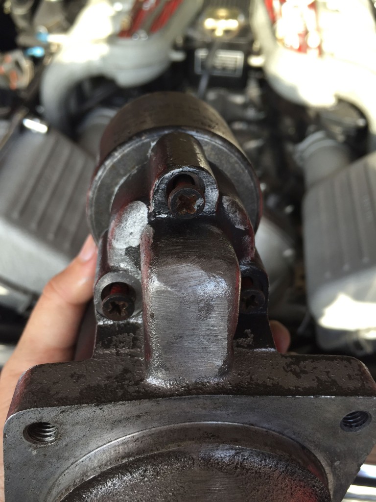 Three Philips-head screws hold the solenoid onto the starter.