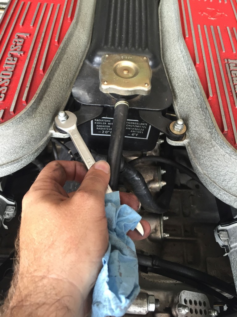 Remove the nuts holding the coolant expansion tank in place.