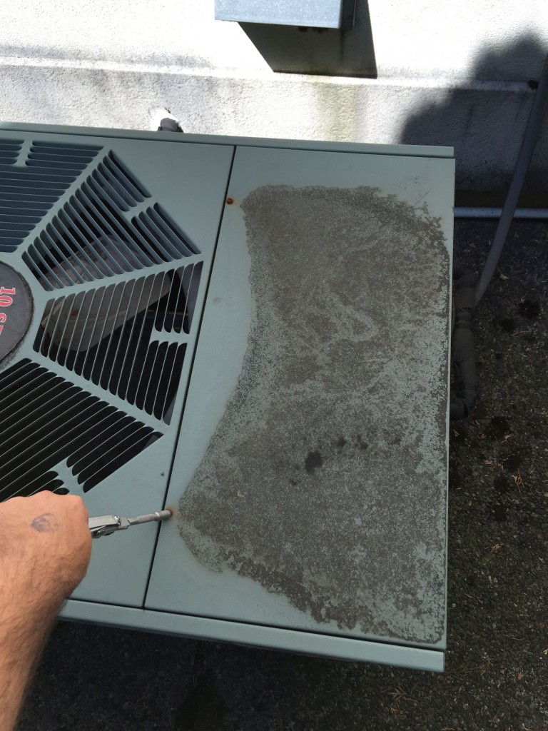 Removing panel screws from a Rheem air conditioner