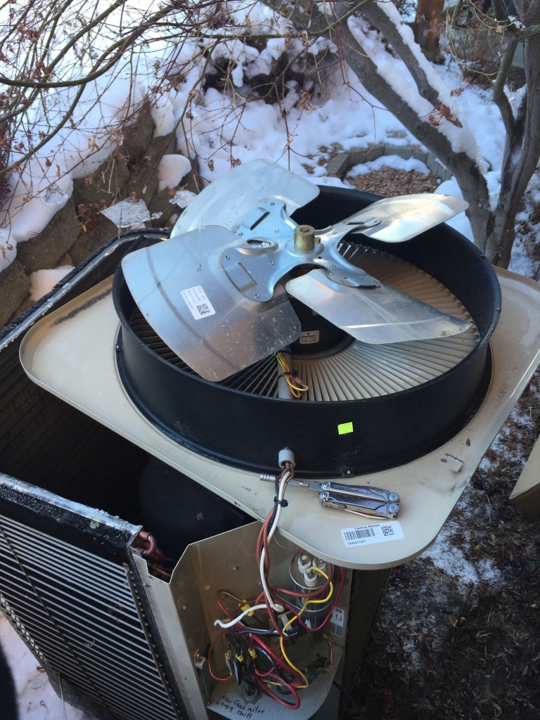 Underside of the top panel of the heat pump exposed