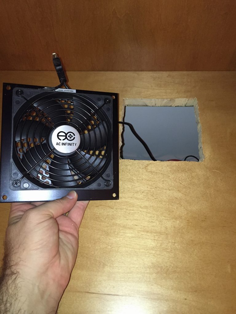Fan ready to be placed in the newly cut hole