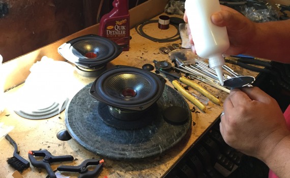 Paul glues new dust covers on the repaired speakers.